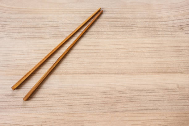 istock chopsticks wooden on wooden top view background. 1075263372