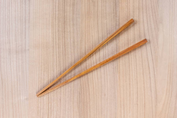 istock chopsticks wooden on wooden top view background. 1075263678