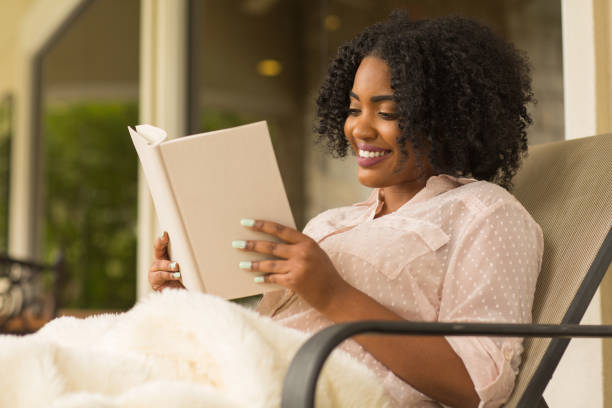 istock African American woman reading a book. 1075275146