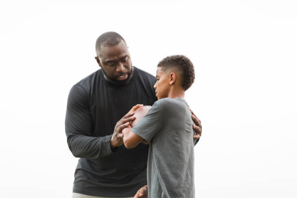 istock American Football coach training a young athlete. 1075277274