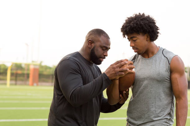 istock American Football coach training a young athlete. 1075278322