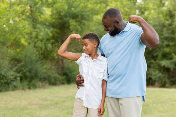 Father and his son laughing and playing outside.