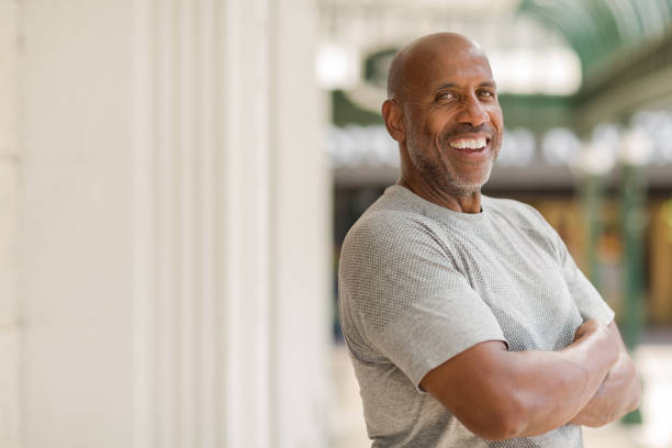Happy mature African American man smiling outside. stock photo