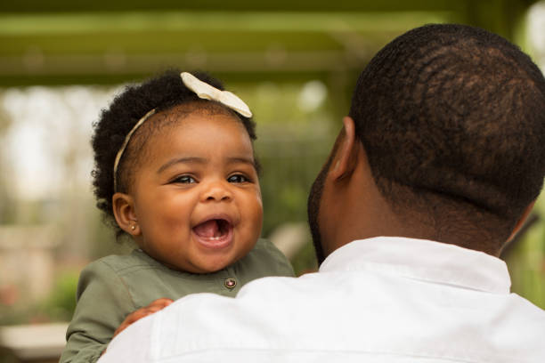 istock African American father holding his daughter. 1075284008