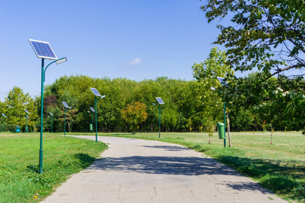 Landscape in Tineretului Park, Bucharest Park alley illuminated by solar powered street lights in Tineretului Park, Bucharest, Romania solar street lights stock pictures, royalty-free photos & images