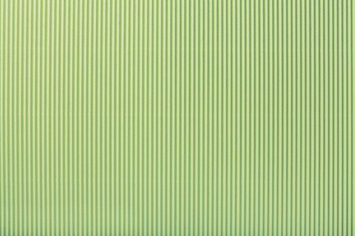 Texture of corrugated light green paper, macro.