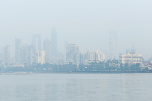 Mumbai, India, 20 November 2018.
Misty morning view of South Mumbai Skyline. 
Due to the Air Pollution the skyscrapers and towers are hardly visible in the background.