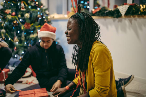 istock Young couple wrapping Christmas presents 1075308756