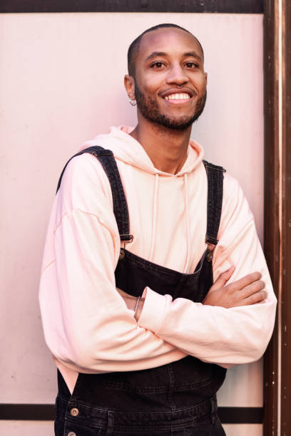 istock Attractive african guy with bib pants outdoors 1075341874