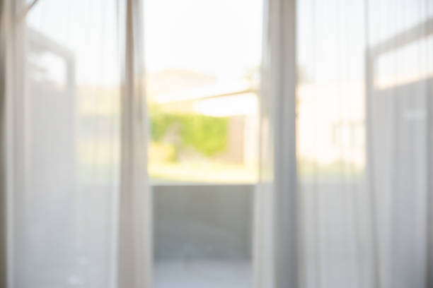 istock Defocused of curtain window with garden view. 1075356350