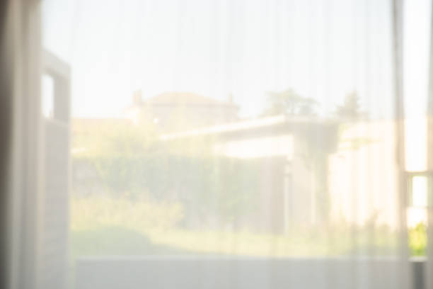 istock Defocused of curtain window with garden view. 1075356390