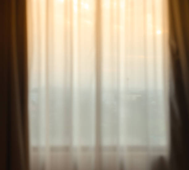 istock Defocused curtain window and stationery box with sunlight. 1075359424