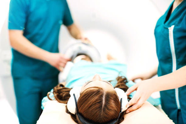 Leg MRI scan. Technicians preparing young female patient for leg mri scan. x ray image medical occupation technician nurse stock pictures, royalty-free photos & images