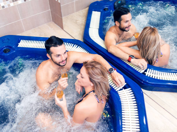 istock Young couple is relaxing in bubbling hot tub 1075365024
