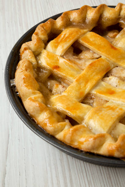 istock Homemade apple pie on white wooden surface, side view. Close up. 1075365412