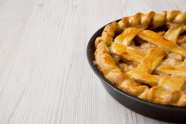 istock Homemade apple pie on white wooden table, side view. Copy space and text area. 1075365420