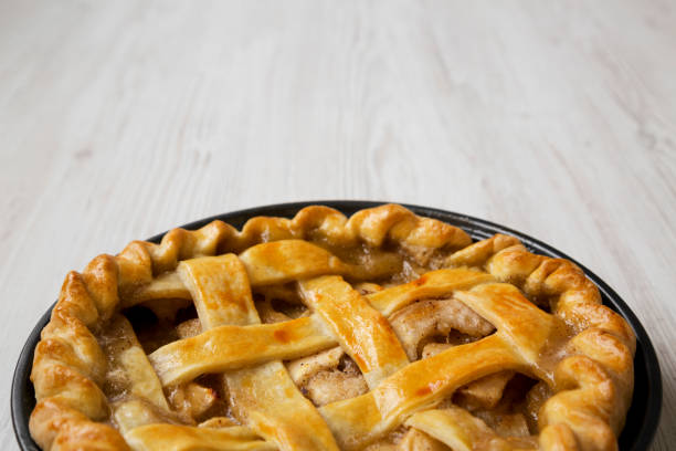 istock Homemade apple pie on white wooden surface, side view. Copy space. 1075365706
