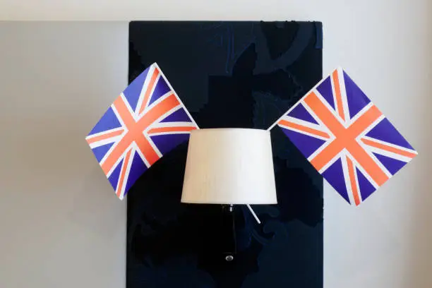 Union Jack flag hanging from light lamp in hotel room uk England