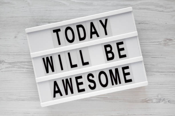 istock 'Today will be awesome' words on modern board over white wooden surface, overhead view. Flat lay, from above. 1075370148