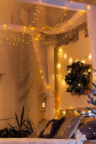 istock White cozy bed and Christmas lights 1075370460