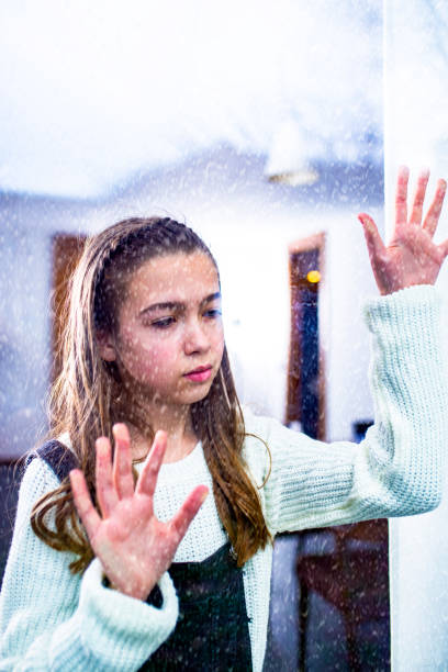 istock Lonely Child Near the Window 1075375662
