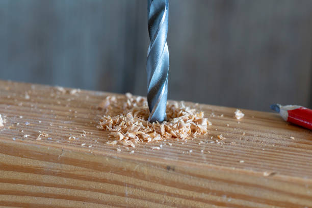 istock metal drill bit make holes in a wooden plank 1075376002