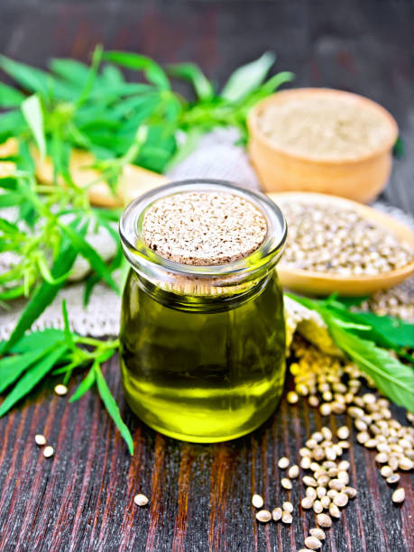 istock Oil hemp in jar with flour and grain on dark board 1075376208