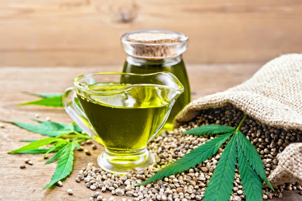 istock Oil hemp in sauceboat and jar on board 1075376226