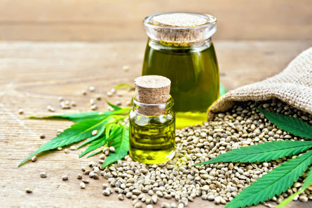 istock Oil hemp in two jars with grain on board 1075376236