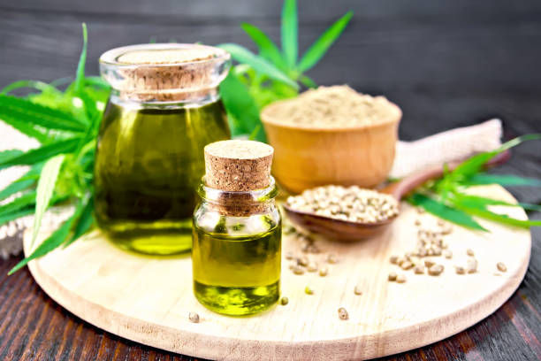 istock Oil hemp in two jars with flour on board 1075376244