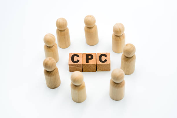 istock Wooden figures as business team in circle around acronym CPC Cost Per Click 1075378416