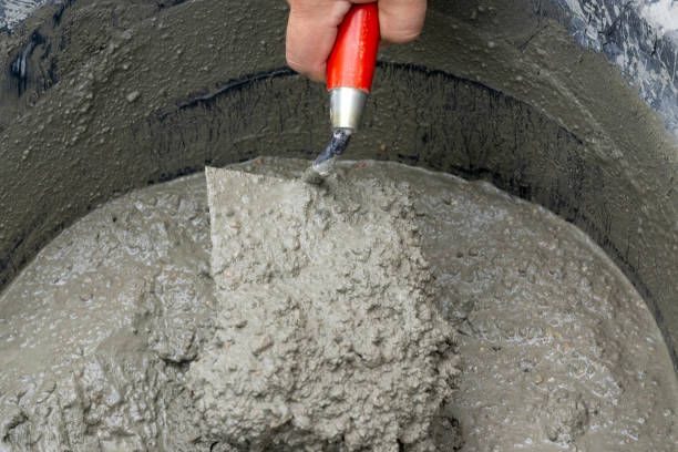 istock Hand holding a trowel with cement mortar in construction site 1075380202