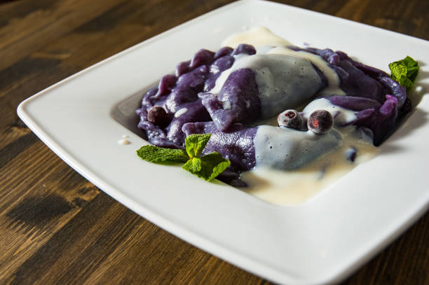 istock Dumplings with blueberries and cream. on a wooden background 1075384866