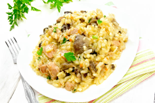 istock Risotto with mushrooms and chicken on light board 1075388658