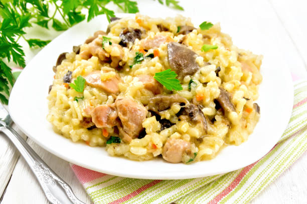 istock Risotto with mushrooms and chicken on table 1075388666