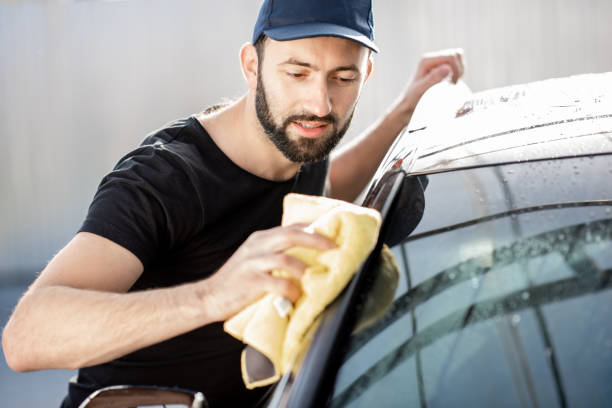 istock Professional washer wiping car window 1075388848
