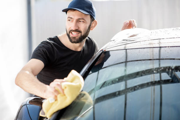 istock Professional washer wiping car window 1075388876
