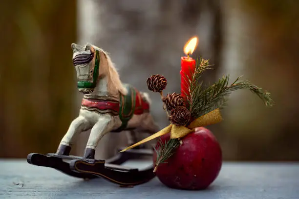 vintage xmas decoration with an old wooden toy horse and candle
