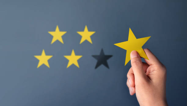 istock Customer Experience Concept, Best Excellent Services for Satisfaction present by Hand of Client giving a Five Star Rating 1075397502