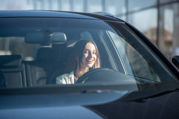 istock Businesswoman driving a car 1075397800