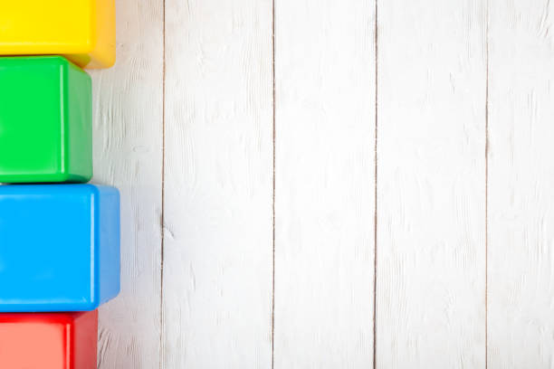 istock Flat lay on wooden background. Children's plastic cubes. Mockup with copy space 1075404134