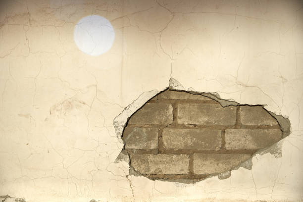 istock The wall caved in, the plaster and the bricks are visible. 1075413794