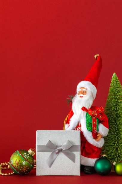 istock Santa Claus figure silver gift box and red background 1075414858