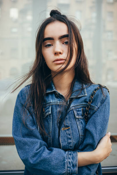 istock Portrait beautiful young woman dressed in classic blue denim jacket 1075424558