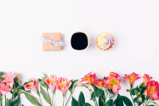 istock Small gift box and cup of coffee with dessert on white background 1075424808
