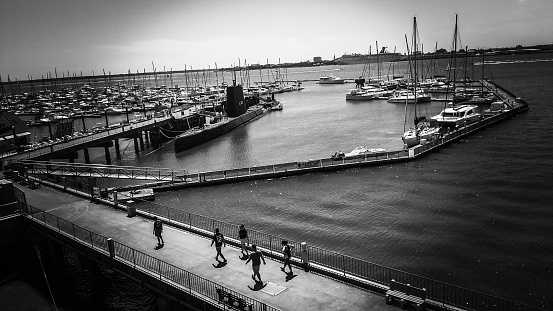 People walking on the dock where ships are boarded