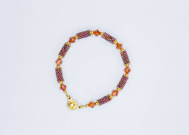 istock multi colored and variously sized beads bracelet on gray background 1075437014