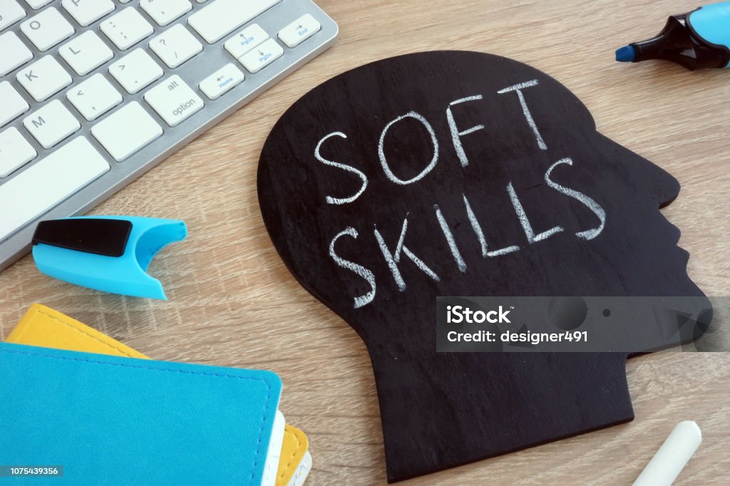 Soft skills written on a blackboard with the shape of a head. Skill Stock Photo