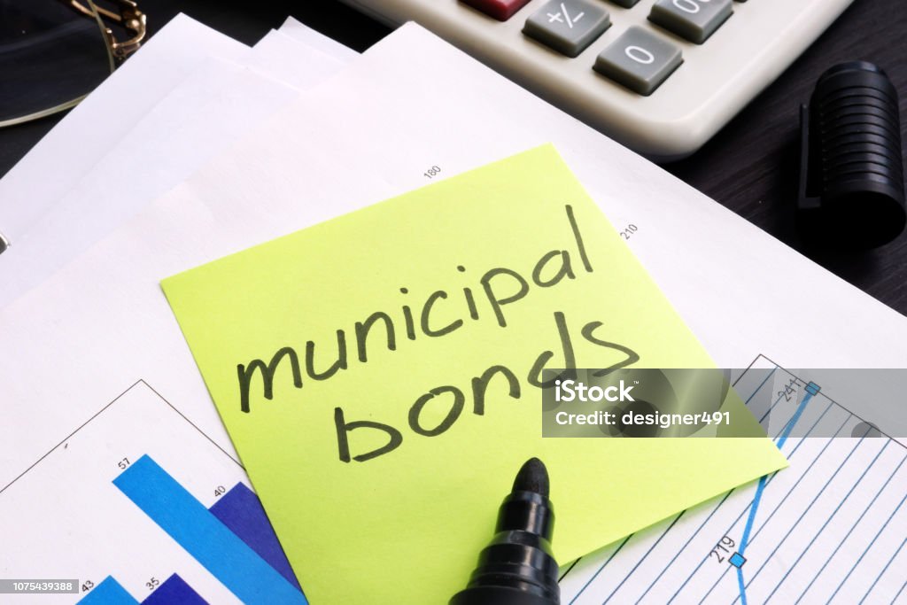 Municipal bond written on a memo stick and documents. Bond - Financial Item Stock Photo