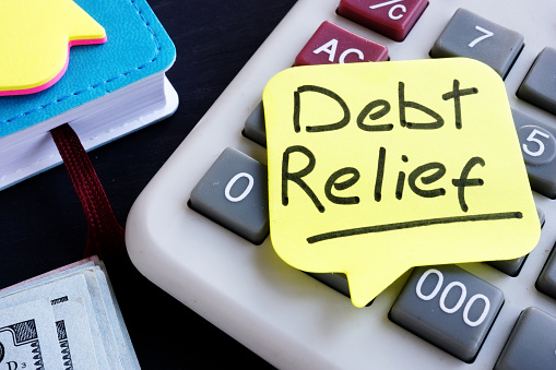 Debt relief concept. Money and calculator on a desk.